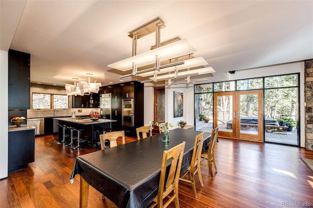 32651 Buffalo Creek Rd, Evergreen, CO 80439 - dining room featuring dark wood-type flooring, french doors, and a chandelier