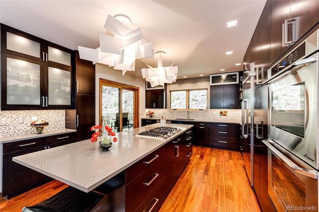 32651 Buffalo Creek Rd, Evergreen, CO 80439 - kitchen featuring appliances with stainless steel finishes, decorative backsplash, light countertops, and recessed lighting