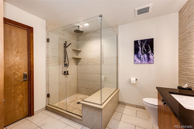 32651 Buffalo Creek Rd, Evergreen, CO 80439 - full bathroom with tile patterned floors, a stall shower, vanity, and toilet