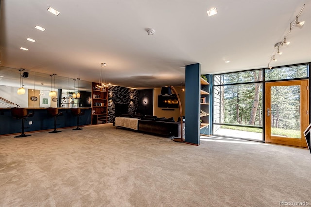 32651 Buffalo Creek Rd, Evergreen, CO 80439 - living area with track lighting, carpet, floor to ceiling windows, and a large fireplace
