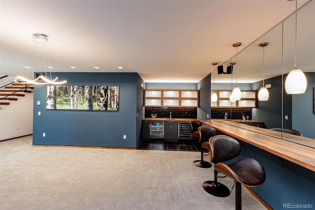 32651 Buffalo Creek Rd, Evergreen, CO 80439 - indoor wet bar featuring wine cooler, dark carpet, tasteful backsplash, stairs, and baseboards