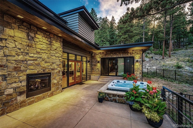32651 Buffalo Creek Rd, Evergreen, CO 80439 - view of patio / terrace featuring french doors and an outdoor hot tub