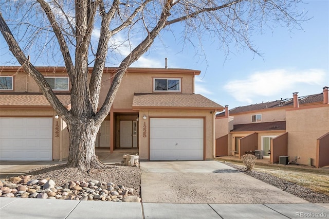 view of front of property featuring central AC and a garage