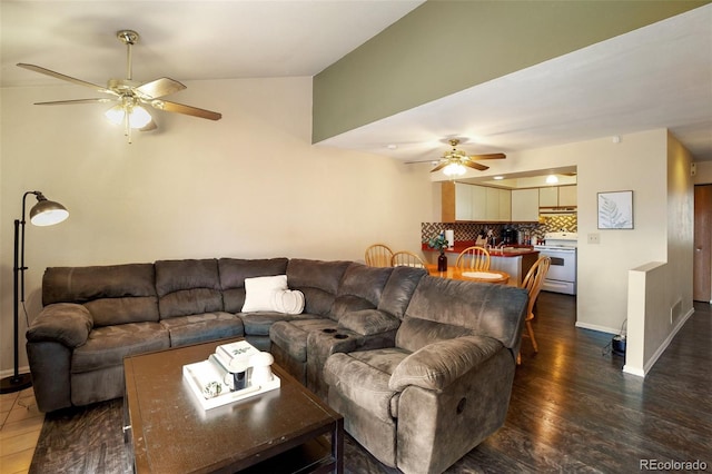 living room with dark wood-type flooring, ceiling fan, and lofted ceiling