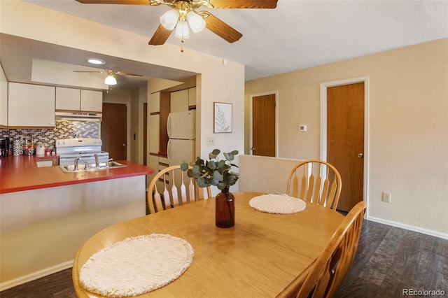 dining space featuring dark hardwood / wood-style floors, ceiling fan, and sink