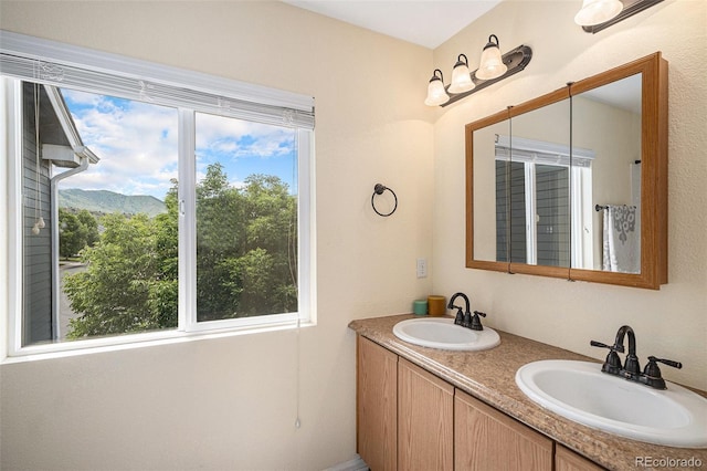 9633 Marmot Ridge Cir, Littleton, CO 80125 - full bathroom with healthy amount of natural light, double vanity, and a mountain view