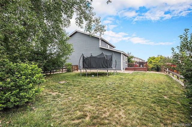 9633 Marmot Ridge Cir, Littleton, CO 80125 - rear view of house featuring a trampoline, a deck, and a fenced backyard