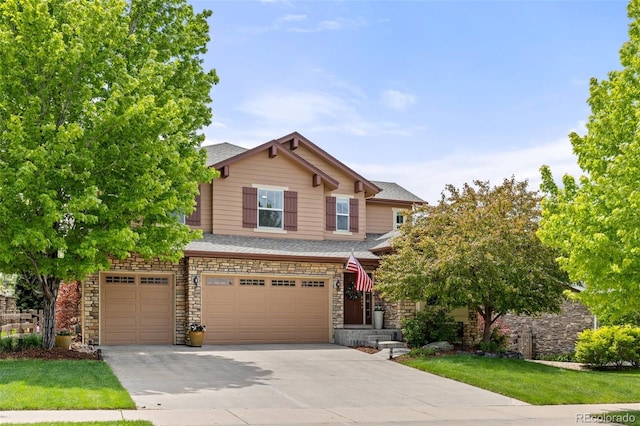 24702 E Ontario Dr, Aurora, CO 80016 - view of front facade featuring concrete driveway, a garage, stone siding, and a shingled roof