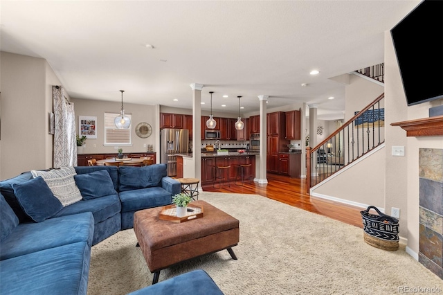 24702 E Ontario Dr, Aurora, CO 80016 - living area featuring stairs, light wood-type flooring, recessed lighting, and baseboards