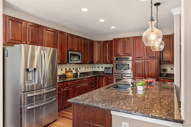 24702 E Ontario Dr, Aurora, CO 80016 - kitchen with stainless steel appliances, tasteful backsplash, pendant lighting, recessed lighting, and a sink