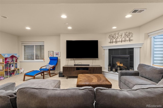 24702 E Ontario Dr, Aurora, CO 80016 - living area featuring light carpet, a tiled fireplace, recessed lighting, and baseboards