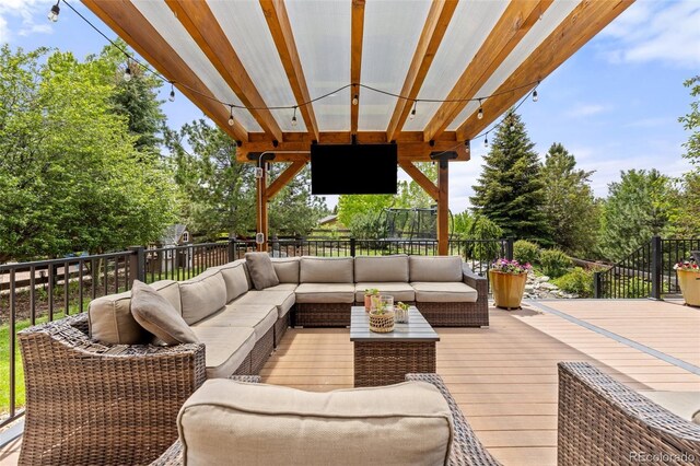 24702 E Ontario Dr, Aurora, CO 80016 - deck with outdoor lounge area and view of wooded area