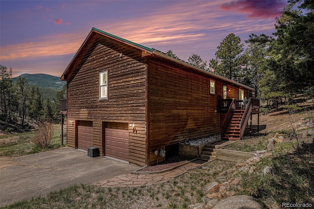 72 Rudi Ln W, Golden, CO 80403 - view of home's exterior featuring driveway, stairway, an attached garage, and a wooden deck