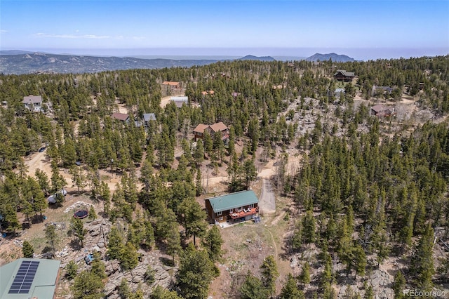 72 Rudi Ln W, Golden, CO 80403 - aerial view of property and surrounding area featuring a heavily wooded area and a mountain backdrop