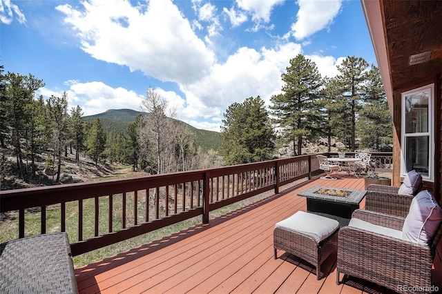 72 Rudi Ln W, Golden, CO 80403 - wooden terrace with an outdoor fire pit and a mountain view