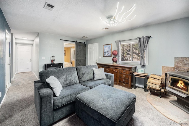 72 Rudi Ln W, Golden, CO 80403 - carpeted living room featuring a barn door and a textured ceiling