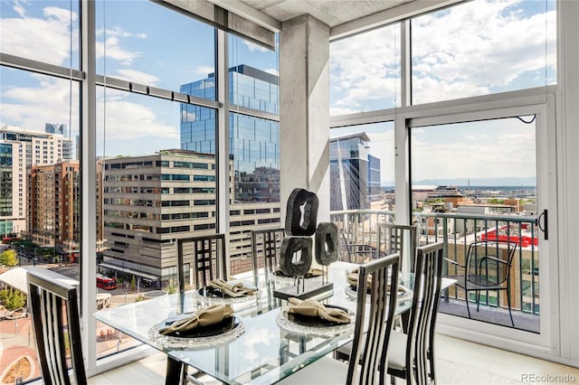 dining space with expansive windows, a view of city, and plenty of natural light