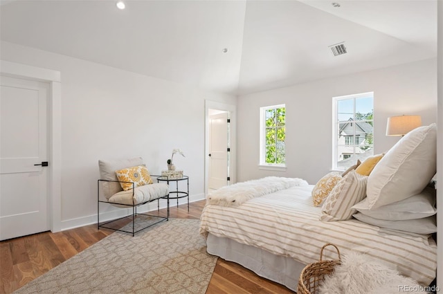 bedroom featuring wood-type flooring and vaulted ceiling