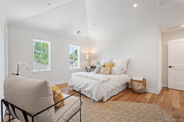 bedroom featuring light hardwood / wood-style flooring and lofted ceiling