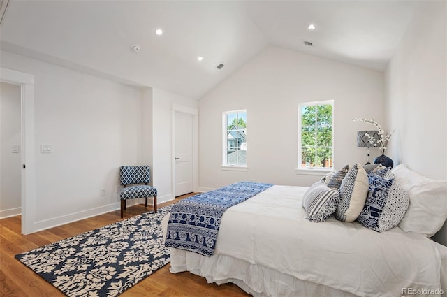 bedroom featuring lofted ceiling and hardwood / wood-style flooring