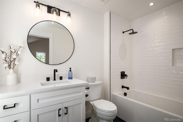 full bathroom with tiled shower / bath combo, vanity, and toilet