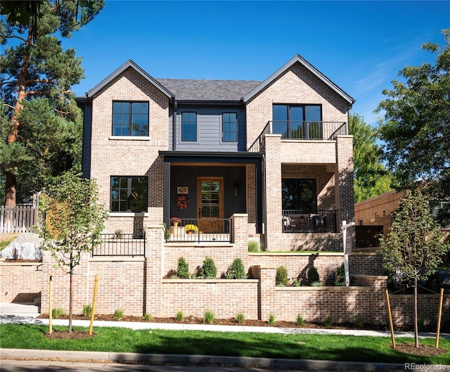 craftsman-style home featuring a balcony and a porch