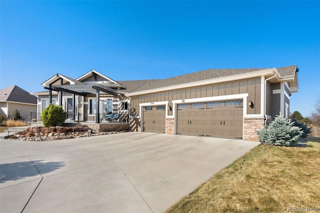 craftsman-style home with a pergola, concrete driveway, a garage, stone siding, and board and batten siding