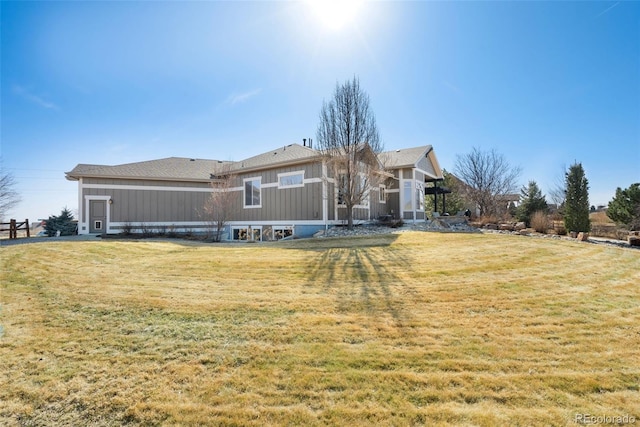 back of house featuring a lawn