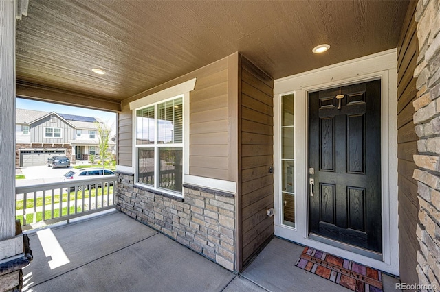 960 S De Gaulle Ct, Aurora, CO 80018 - doorway to property featuring covered porch and stone siding