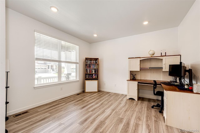 960 S De Gaulle Ct, Aurora, CO 80018 - home office featuring light wood-style floors, baseboards, recessed lighting, and built in desk