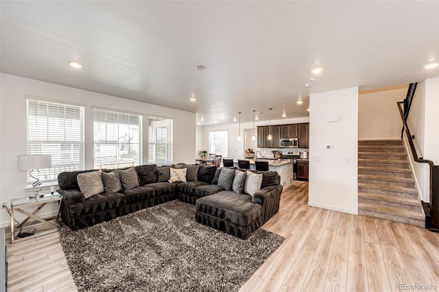 960 S De Gaulle Ct, Aurora, CO 80018 - living area featuring light wood-style flooring, stairway, and recessed lighting