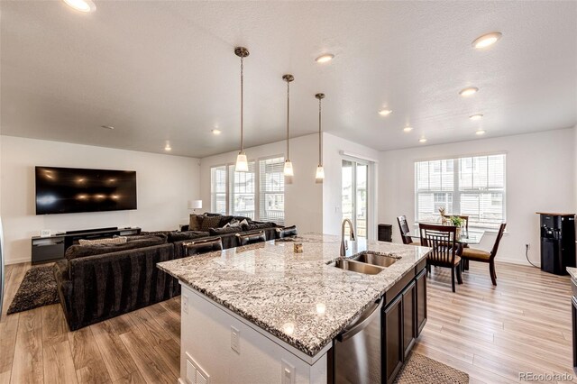 960 S De Gaulle Ct, Aurora, CO 80018 - kitchen with a sink, dishwasher, light wood finished floors, an island with sink, and recessed lighting