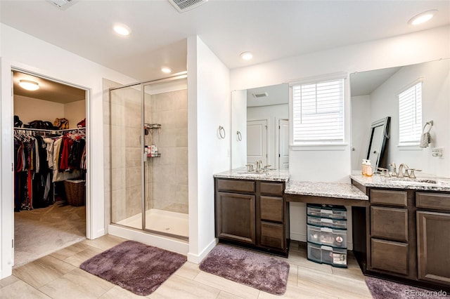 960 S De Gaulle Ct, Aurora, CO 80018 - full bathroom featuring a stall shower, vanity, wood finish floors, a spacious closet, and recessed lighting