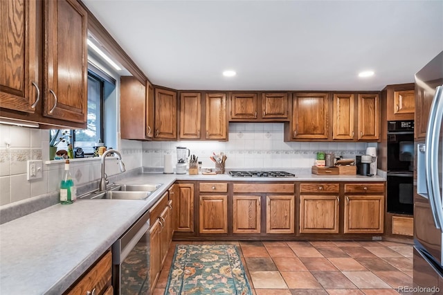 7815 Armadillo Trl, Evergreen, CO 80439 - kitchen featuring a sink, decorative backsplash, brown cabinets, light countertops, and appliances with stainless steel finishes