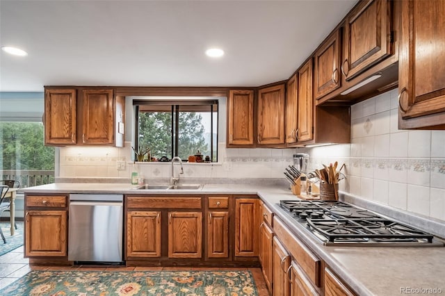 7815 Armadillo Trl, Evergreen, CO 80439 - kitchen with a wealth of natural light, a sink, brown cabinetry, and appliances with stainless steel finishes