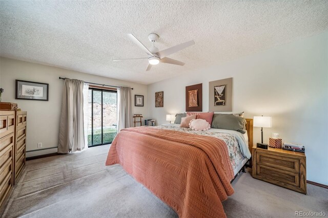 7815 Armadillo Trl, Evergreen, CO 80439 - bedroom featuring access to exterior, light carpet, a baseboard radiator, a textured ceiling, and ceiling fan