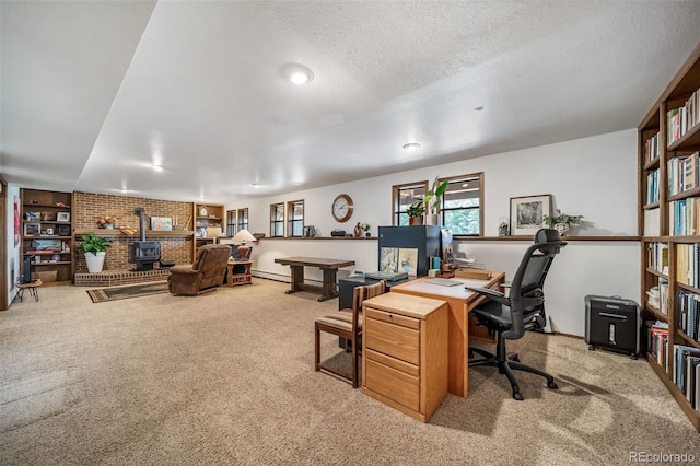 7815 Armadillo Trl, Evergreen, CO 80439 - office with a textured ceiling, carpet, and a wood stove