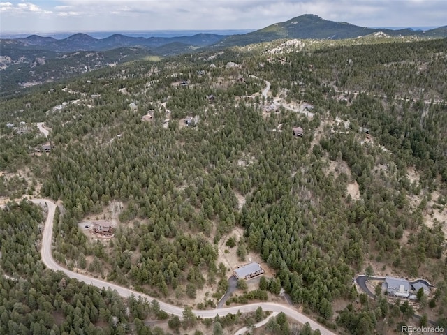 7815 Armadillo Trl, Evergreen, CO 80439 - drone / aerial view featuring a wooded view and a mountain view