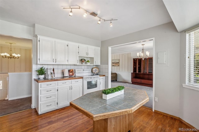 1244 Baron Rd, Colorado Springs, CO 80918 - kitchen with white range with electric cooktop, a chandelier, and white cabinetry