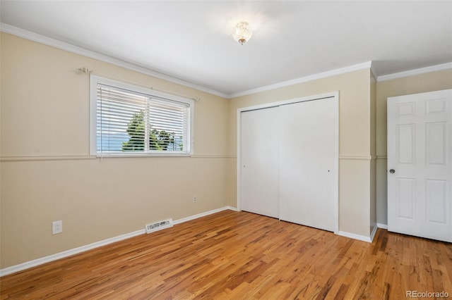 1244 Baron Rd, Colorado Springs, CO 80918 - unfurnished bedroom with ornamental molding, light wood-style floors, and a closet