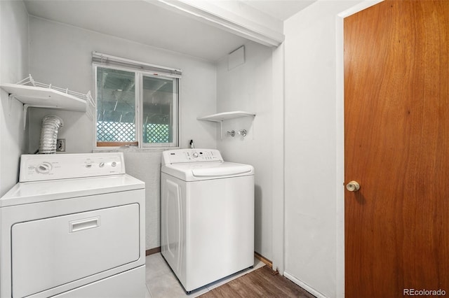 1244 Baron Rd, Colorado Springs, CO 80918 - laundry area with separate washer and dryer and light wood finished floors