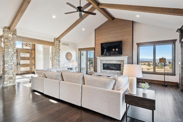 living room featuring beam ceiling, high vaulted ceiling, dark hardwood / wood-style flooring, and a fireplace