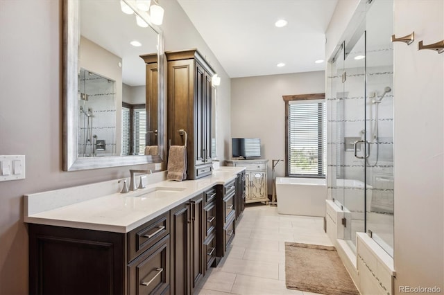 bathroom with tile patterned flooring, vanity, and independent shower and bath