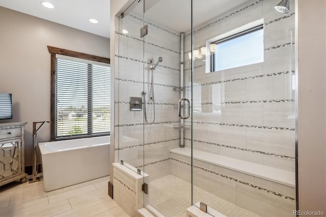 bathroom with tile patterned flooring, vanity, and independent shower and bath