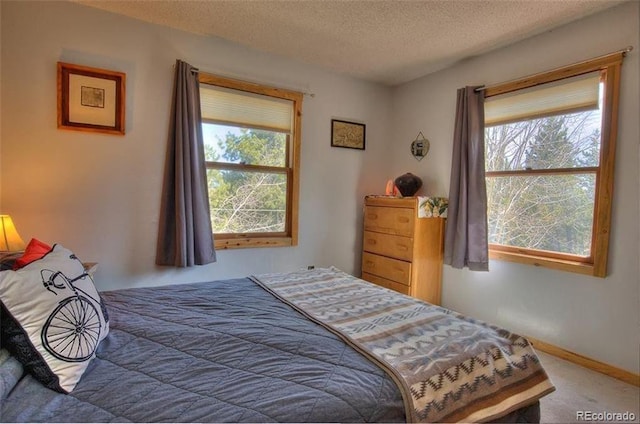 carpeted bedroom featuring a textured ceiling