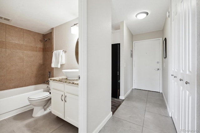 full bathroom with toilet, tile patterned floors, vanity, and tiled shower / bath combo