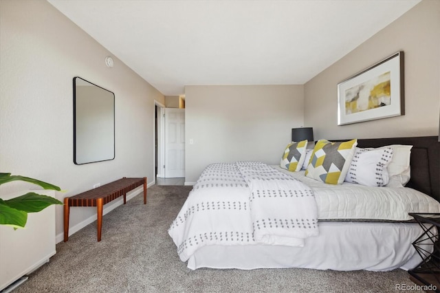 bedroom featuring baseboards and carpet