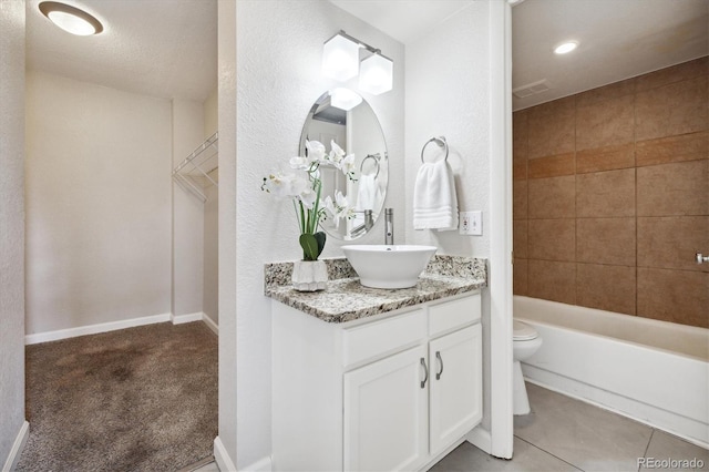 full bathroom featuring vanity, tiled shower / bath combo, and toilet