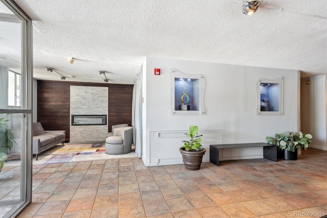 interior space with a fireplace and a textured ceiling