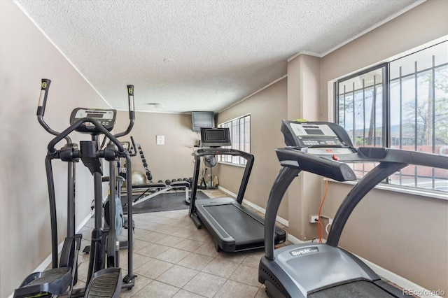 workout area featuring baseboards and a textured ceiling